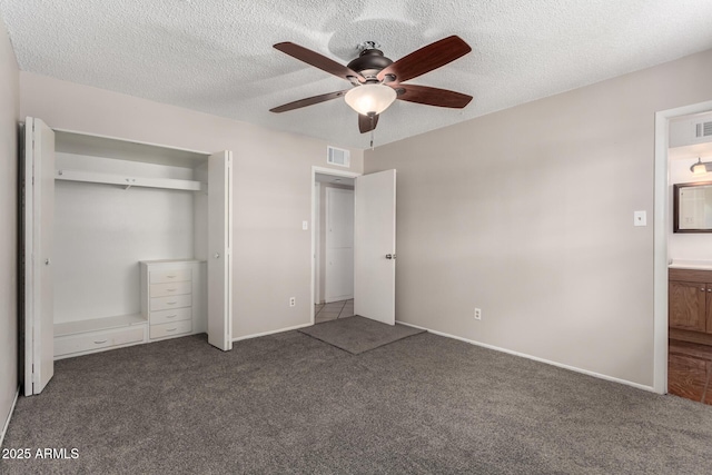 unfurnished bedroom featuring visible vents, a textured ceiling, and carpet flooring