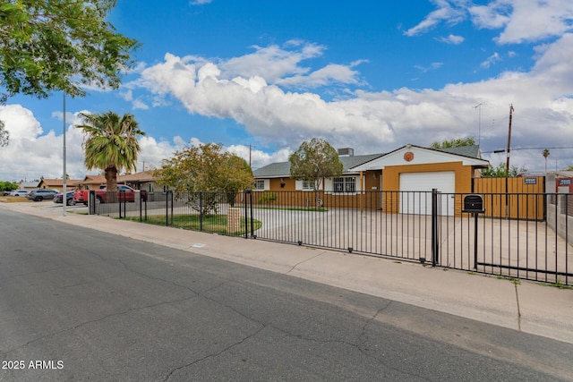 view of front of property featuring a fenced front yard, a residential view, a garage, and a gate