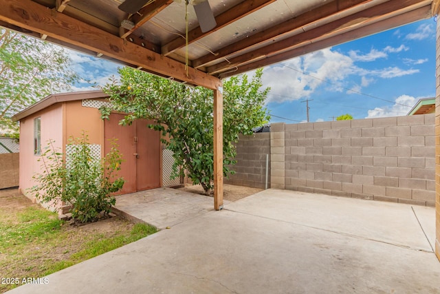 view of patio / terrace featuring an outbuilding and fence