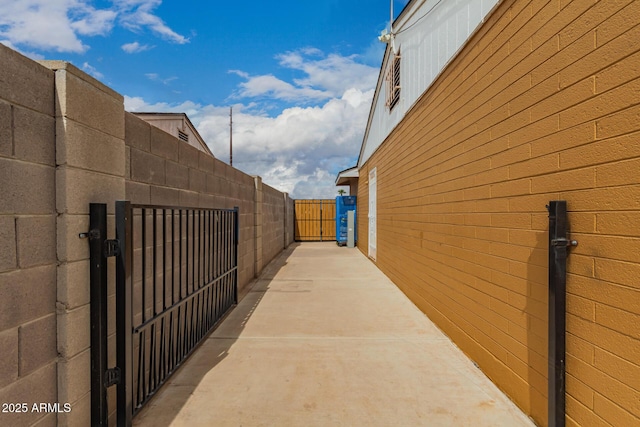 view of side of home featuring a gate and fence