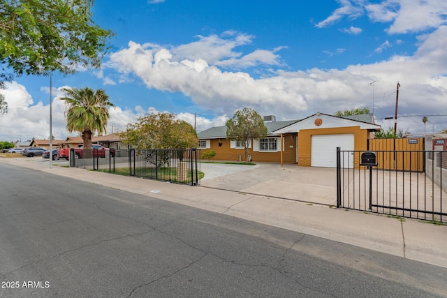 ranch-style house featuring driveway, a garage, and fence