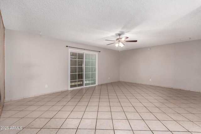 unfurnished room featuring a ceiling fan and a textured ceiling