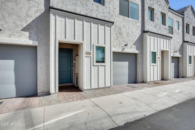 doorway to property featuring stucco siding