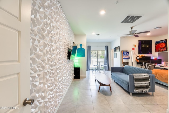 living area with visible vents, ceiling fan, and light tile patterned flooring