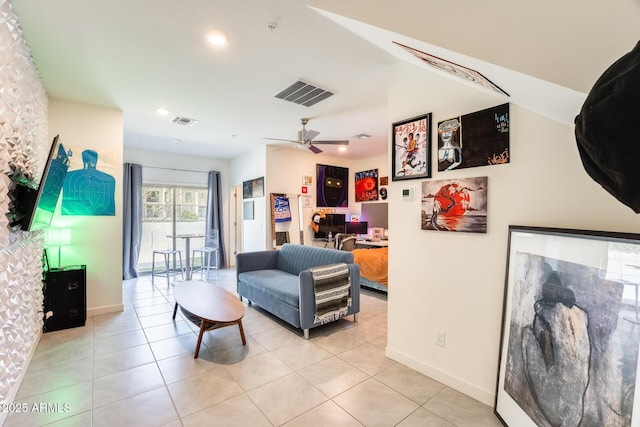 living area featuring visible vents, ceiling fan, baseboards, and light tile patterned floors