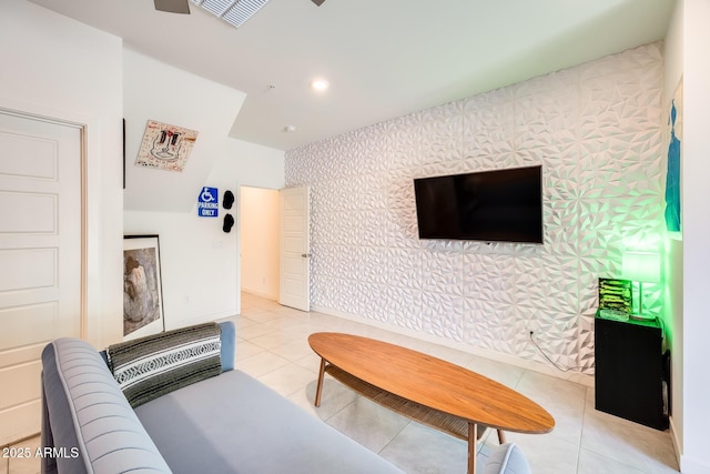 living room with light tile patterned floors, recessed lighting, an accent wall, baseboards, and wallpapered walls