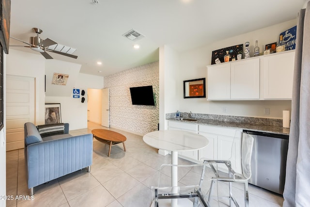 living room featuring light tile patterned floors, ceiling fan, visible vents, and recessed lighting