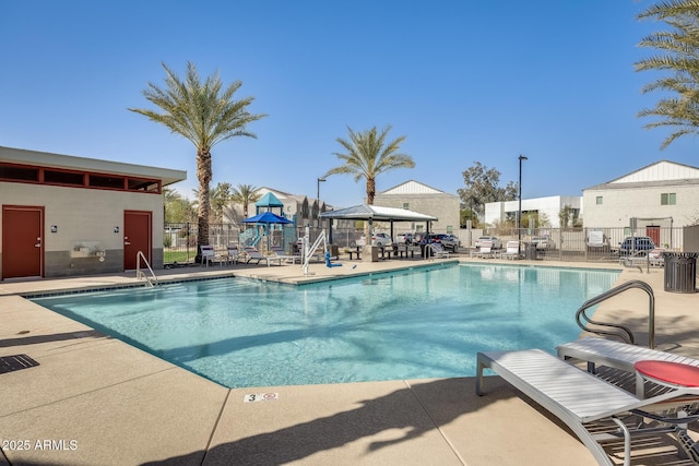 community pool featuring a gazebo, a patio, and fence