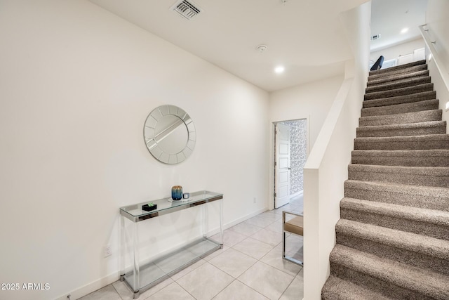 stairs with baseboards, recessed lighting, visible vents, and tile patterned floors