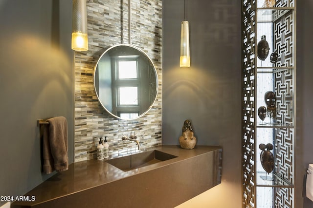 bathroom featuring backsplash and sink