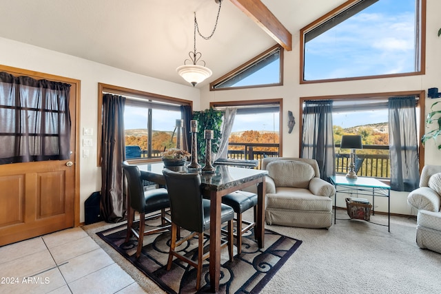 tiled dining area featuring beam ceiling and high vaulted ceiling