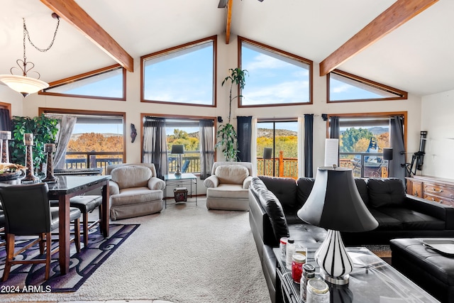 carpeted living room with beamed ceiling and high vaulted ceiling