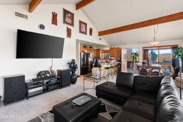 carpeted living room with beamed ceiling and high vaulted ceiling