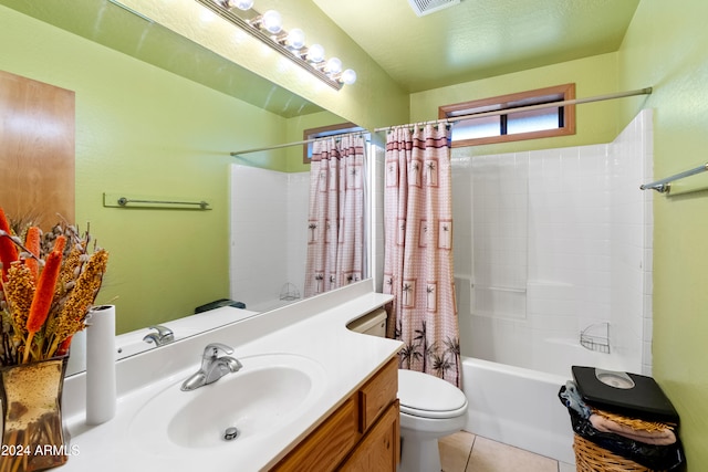 full bathroom featuring vanity, tile patterned flooring, toilet, shower / bath combo with shower curtain, and a textured ceiling