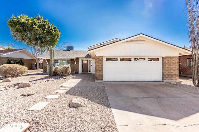 ranch-style house featuring cooling unit and a garage