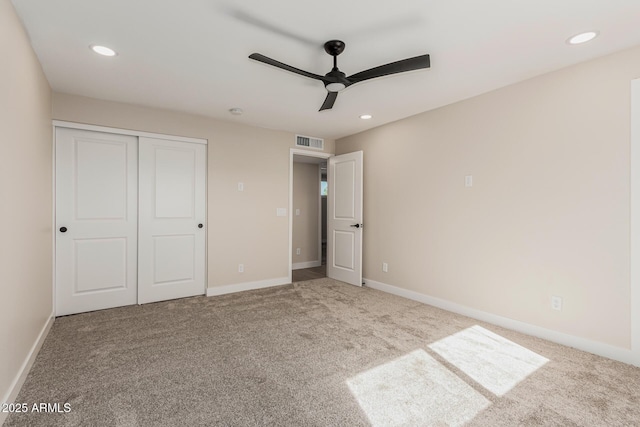 unfurnished bedroom with carpet floors, ceiling fan, and a closet