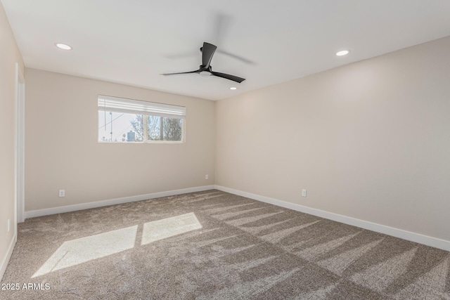 unfurnished room with ceiling fan and carpet