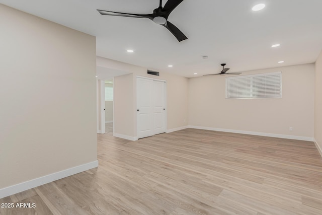 empty room featuring ceiling fan and light wood-type flooring