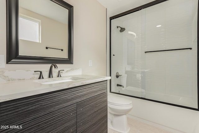 full bathroom with vanity, shower / bath combination with glass door, and toilet