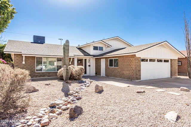 ranch-style house with central AC and a garage