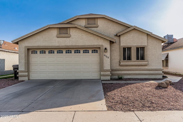 8566 N 108th Ln, Peoria, AZ 85345 - view of front of home featuring a garage, concrete driveway, and stucco siding