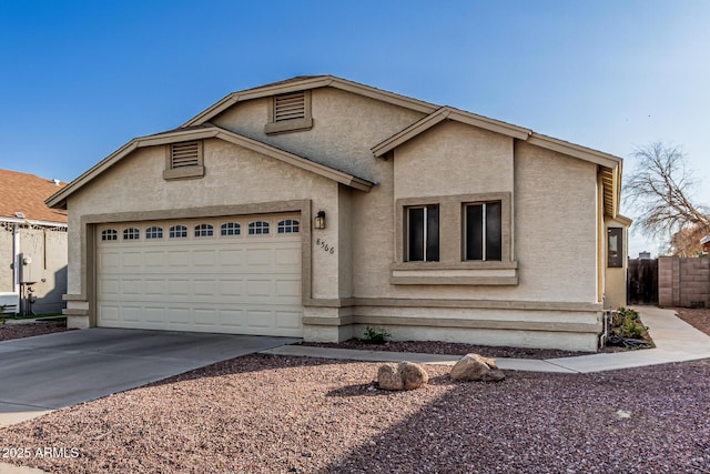 8566 N 108th Ln, Peoria, AZ 85345 - view of front of home featuring a garage, driveway, and stucco siding