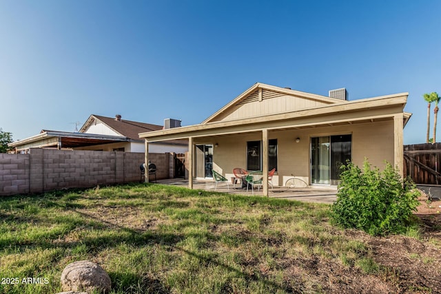 8566 N 108th Ln, Peoria, AZ 85345 - back of property with a patio area, a fenced backyard, and concrete block siding