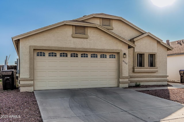 8566 N 108th Ln, Peoria, AZ 85345 - view of front of property featuring driveway, a garage, and stucco siding
