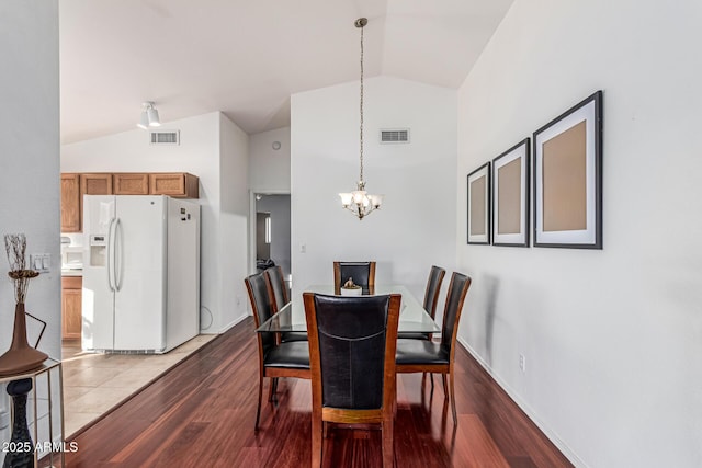 8566 N 108th Ln, Peoria, AZ 85345 - dining room featuring a chandelier, wood finished floors, and high vaulted ceiling