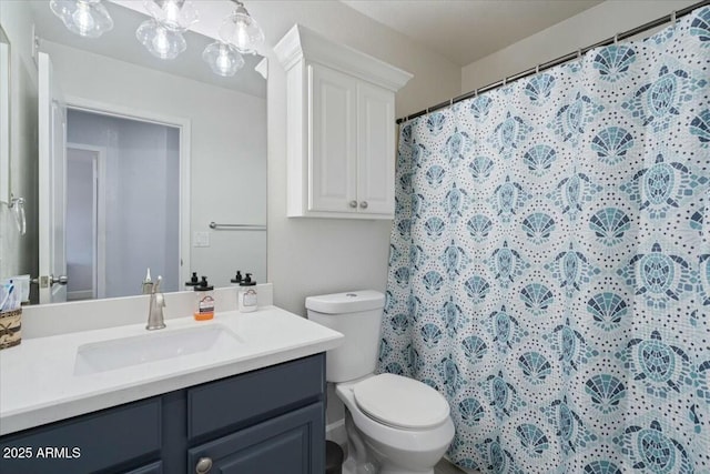 bathroom with a shower with curtain, vanity, and toilet