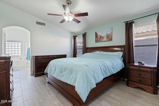 bedroom with connected bathroom, vaulted ceiling, and ceiling fan