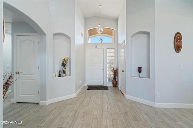 entrance foyer featuring high vaulted ceiling