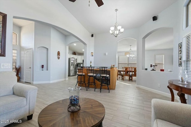 living room featuring ceiling fan with notable chandelier