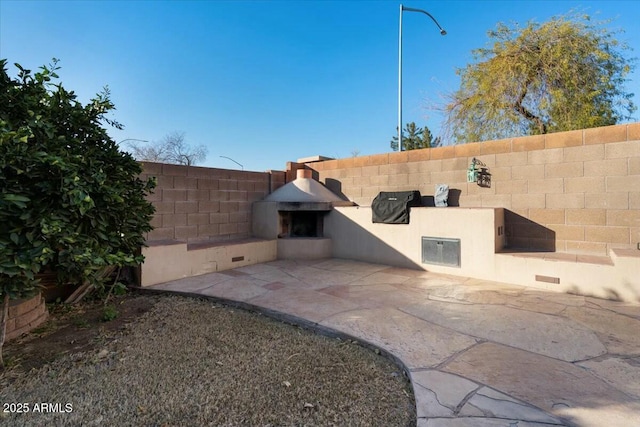 view of patio / terrace with exterior fireplace