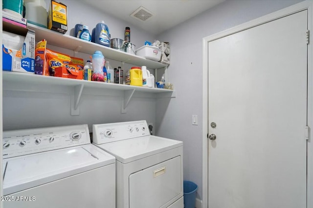 clothes washing area featuring separate washer and dryer