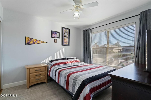 bedroom with dark hardwood / wood-style floors and ceiling fan