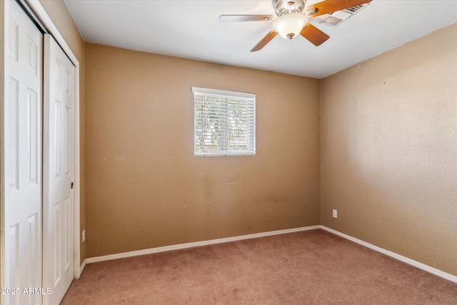 unfurnished bedroom featuring a closet, ceiling fan, and carpet flooring