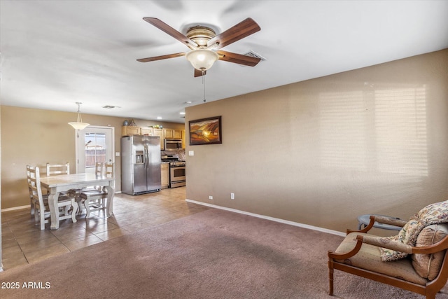 interior space featuring light tile patterned floors and ceiling fan