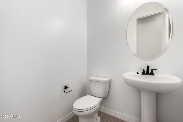 bathroom with sink, wood-type flooring, and toilet