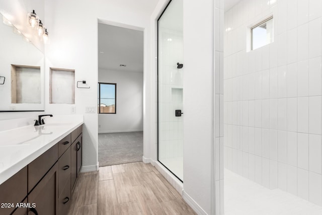 bathroom featuring vanity and tiled shower