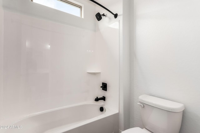 bathroom featuring shower / bath combination and toilet