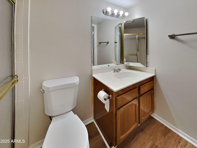 16635 N Cave Creek Rd Unit 232, Phoenix, AZ 85032 - bathroom featuring vanity, a shower with door, wood finished floors, toilet, and baseboards