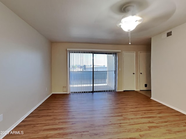 16635 N Cave Creek Rd Unit 232, Phoenix, AZ 85032 - spare room with baseboards, wood finished floors, and visible vents