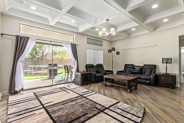 living room featuring hardwood / wood-style floors, an inviting chandelier, coffered ceiling, and beam ceiling