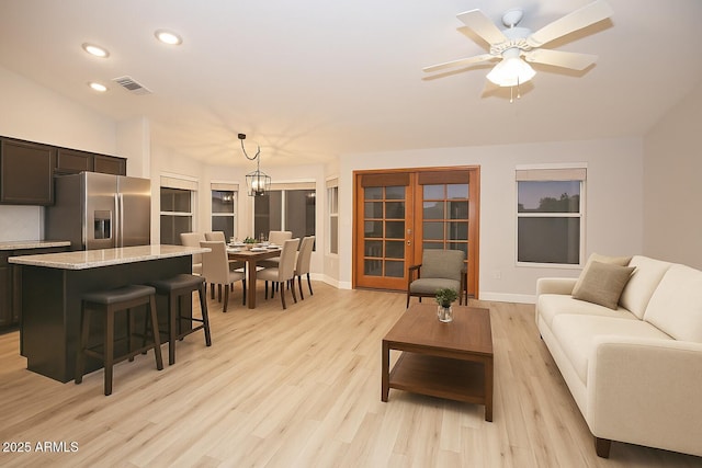 5941 W Venus Way, Chandler, AZ 85226 - living room featuring recessed lighting, light wood-style flooring, a chandelier, ceiling fan, and baseboards
