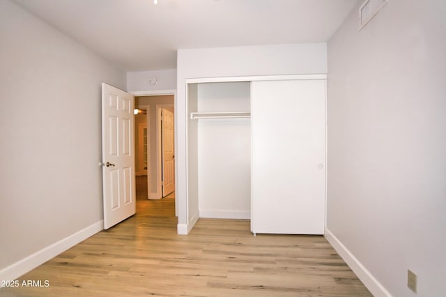 5941 W Venus Way, Chandler, AZ 85226 - unfurnished bedroom with baseboards, light wood-style flooring, and a closet