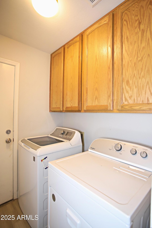 5941 W Venus Way, Chandler, AZ 85226 - laundry room featuring washer and clothes dryer, cabinet space, and wood finished floors