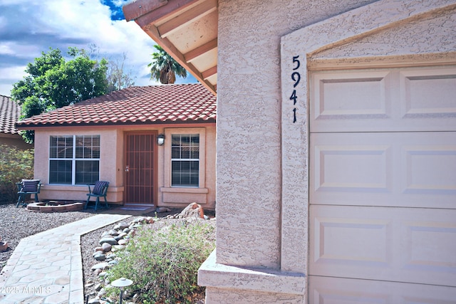 5941 W Venus Way, Chandler, AZ 85226 - doorway to property featuring stucco siding, a tiled roof, and a garage