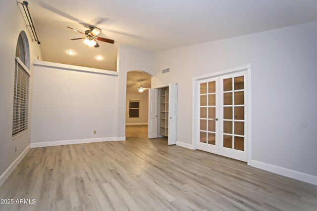 5941 W Venus Way, Chandler, AZ 85226 - unfurnished living room featuring ceiling fan, french doors, wood finished floors, baseboards, and high vaulted ceiling