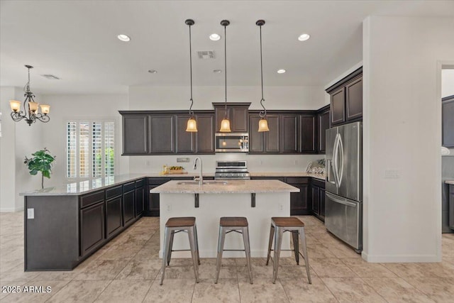 2145 N 88th St, Mesa, AZ 85207 - kitchen featuring light stone countertops, a sink, a center island with sink, visible vents, and appliances with stainless steel finishes